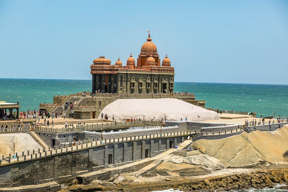 A scenic view of Vivekananda Rock Memorial surrounded by ocean in India.