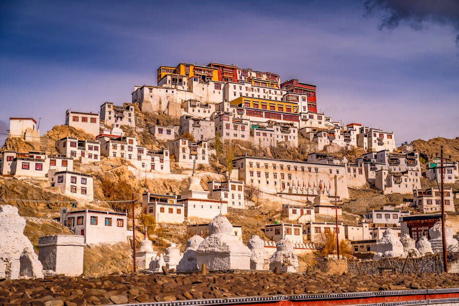 A stunning view of Thiksey Monastery against a warm sunset sky, showcasing its grandeur.