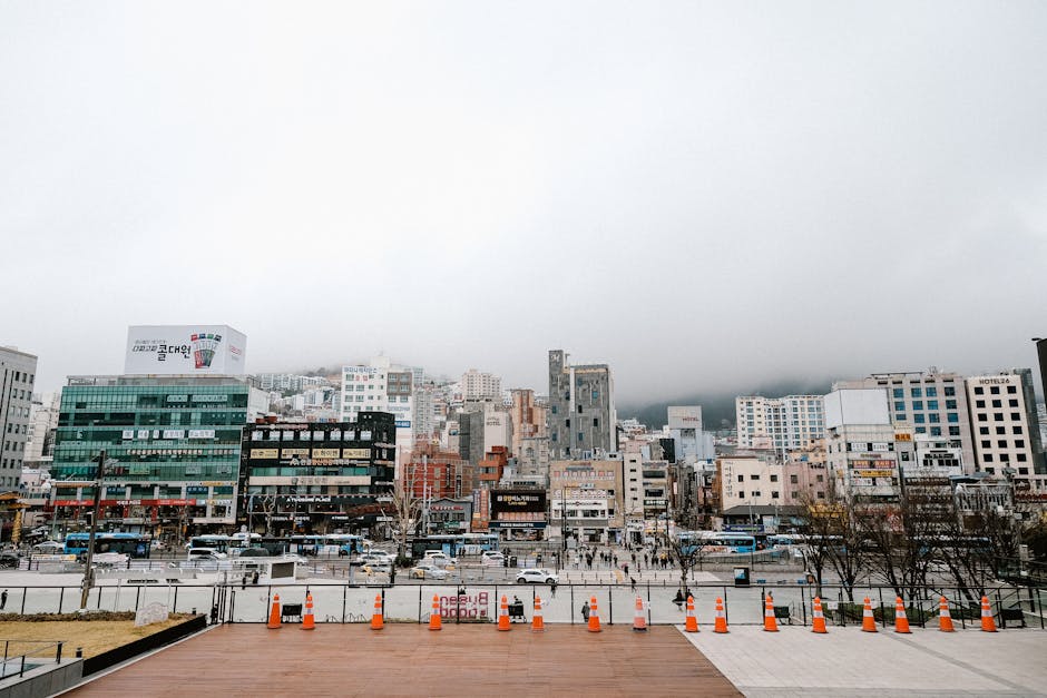 Street view of a bustling South Korean cityscape with traffic and modern buildings.
