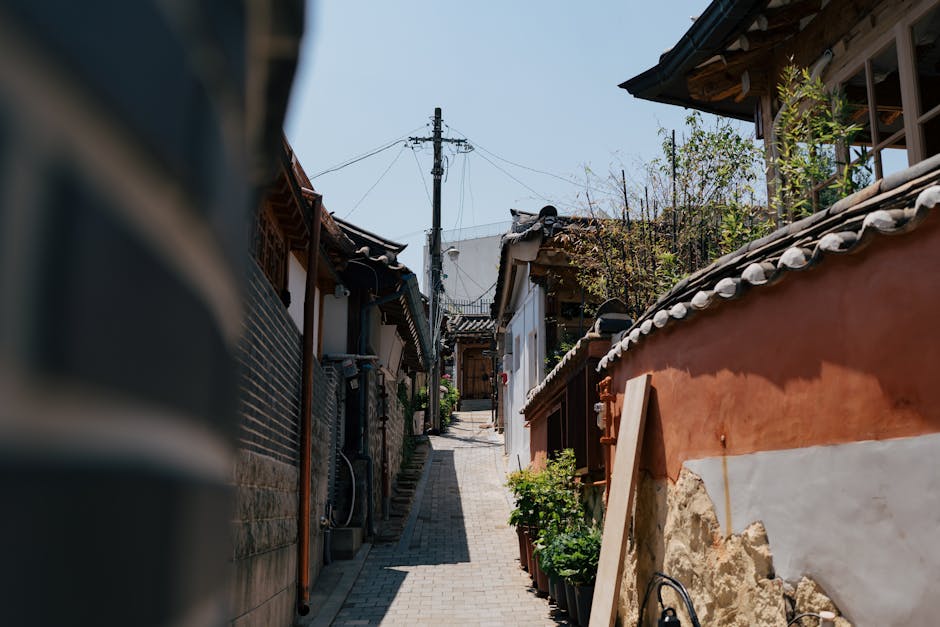 Charming alleyway in a South Korean Hanok village on a sunny day.